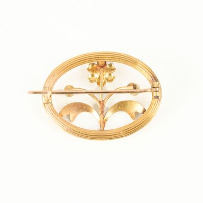 Oval gold brooch set with small cultured...