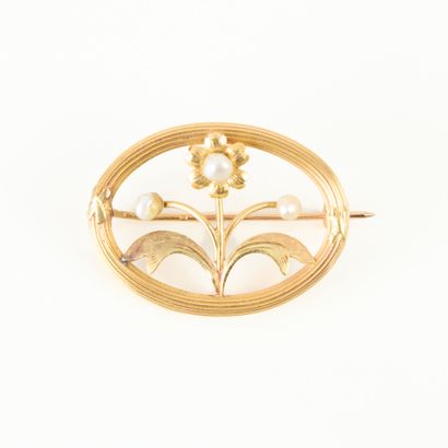 Oval gold brooch set with small cultured...
