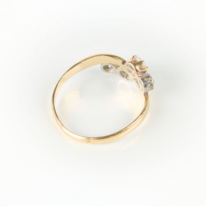 Two-tone gold ring set with three small diamonds...