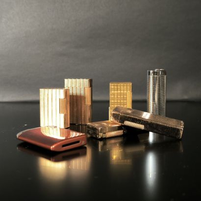 S.T. DUPONT. 2 lighters: gold-plated guilloché,...