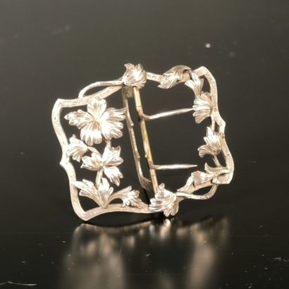 Silver belt buckle decorated with flowers,...