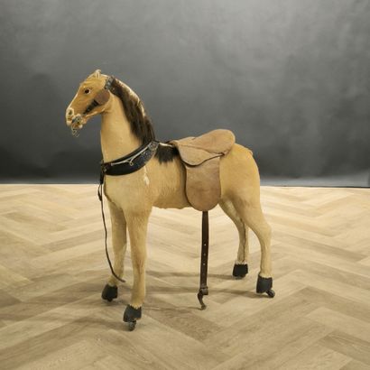 Small skin-covered child's horse on wheels....