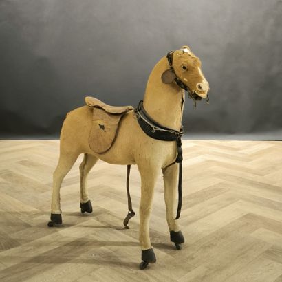 Small skin-covered child's horse on wheels....