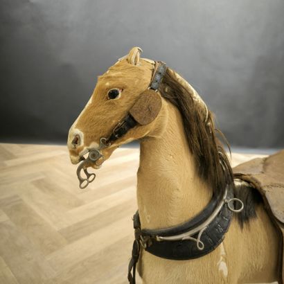 Small skin-covered child's horse on wheels....