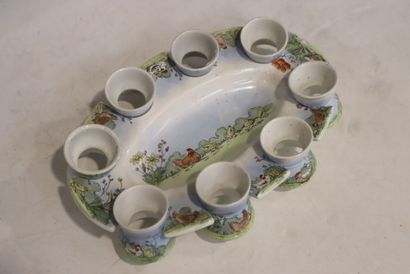 Earthenware egg service with historiated...