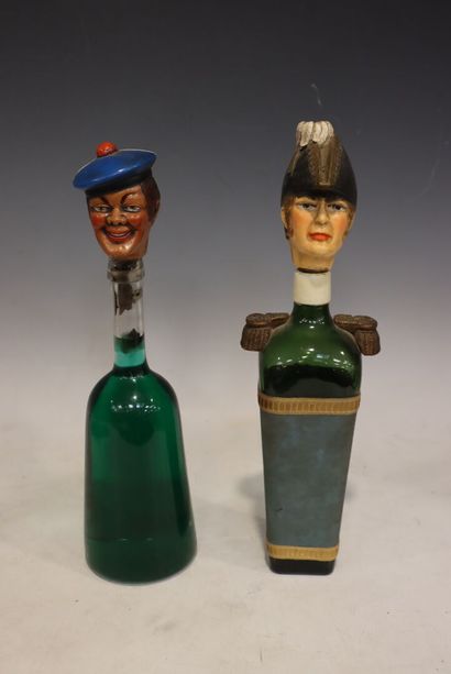 Two bottles with decorative stoppers: an...