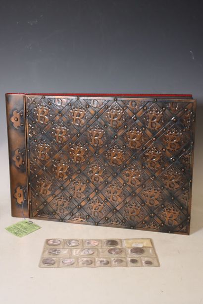 An empty photo album with metal covers featuring...