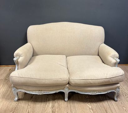 Beige fabric bench resting on 6 curved wooden...