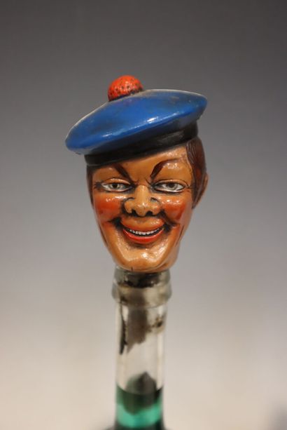 Two bottles with decorative stoppers: an...