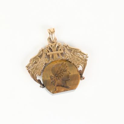 Gold pendant holding a tiger's eye decorated...