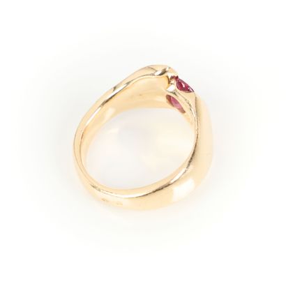Gold cross ring set with an oval ruby weighing...