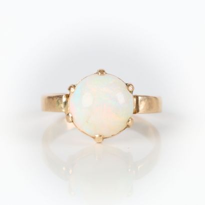 Rose gold ring set with a round cabochon...
