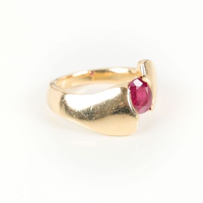 Gold cross ring set with an oval ruby weighing...