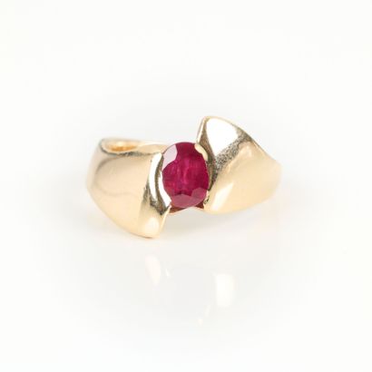 Gold cross ring set with an oval ruby weighing...
