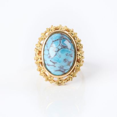 Two-tone gold ring set with a turquoise cabochon...