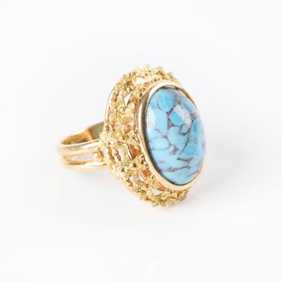 Two-tone gold ring set with a turquoise cabochon...