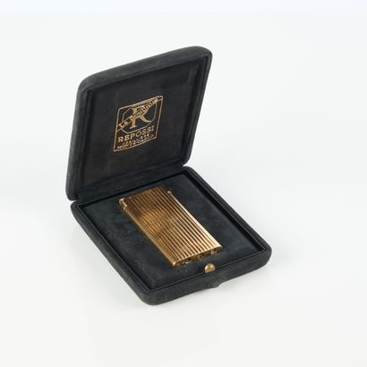 REPOSSI. Gold and engraved metal lighter....