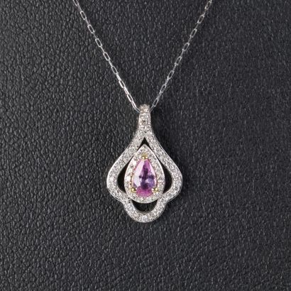 Platinum pendant set with an oval pink sapphire...