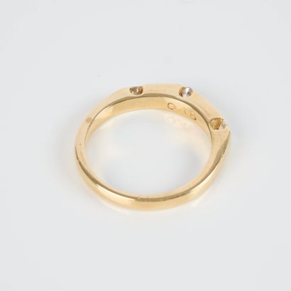 Gold ring (750‰), set with three enclosed...