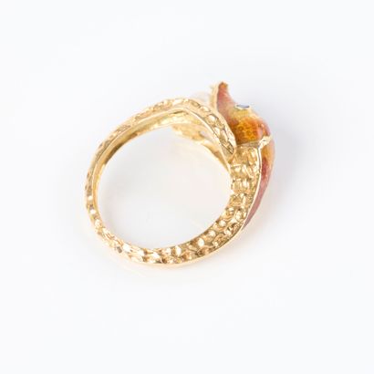 Yellow gold ring featuring a snake holding...