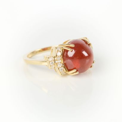 Gold ring (750‰) set with a round cabochon...