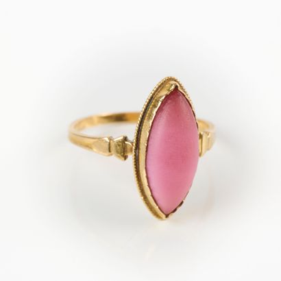 Gold ring set with a pink navette stone....