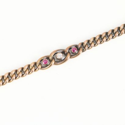Curb chain in gold, set with a round diamond...