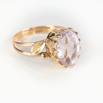 Rose gold ring set with an oval blue semi-precious...