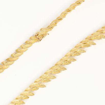 Articulated gold necklace with falling amati...