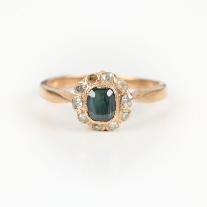 Gold daisy ring, set with a sapphire in a...