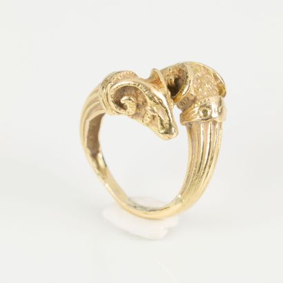 Gold ring featuring interlocking ram heads...