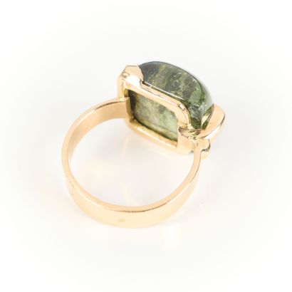 Contemporary gold ring set with a fine cabochon...