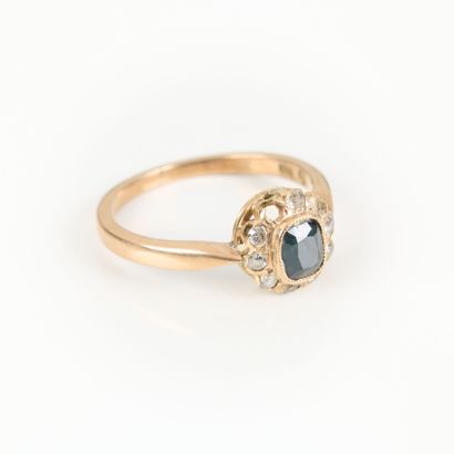 Gold daisy ring, set with a sapphire in a...