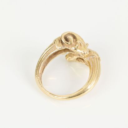 Gold ring featuring interlocking ram heads...