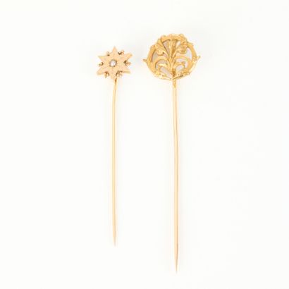 Two gold tie pins, one with a star motif...