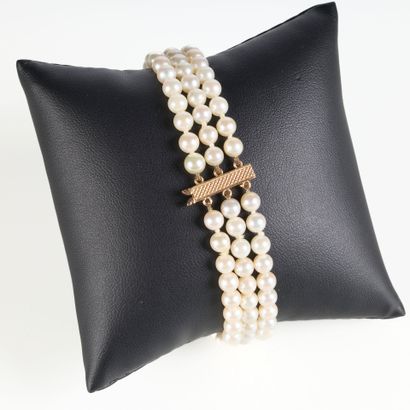Bracelet with three strands of cultured pearls...