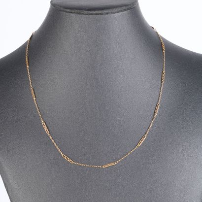 Gold chain with oval links interspersed with...