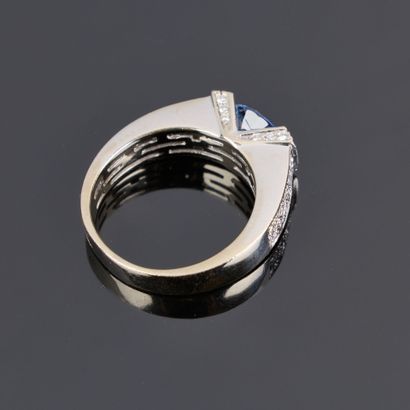 Gold ring set with an oval sapphire weighing...