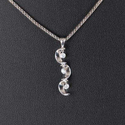 White gold pendant set with three small pierced...