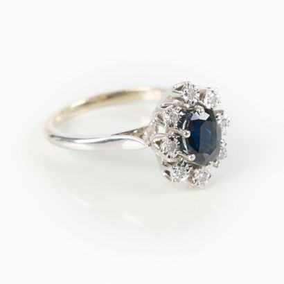 White gold ring set with an oval sapphire...