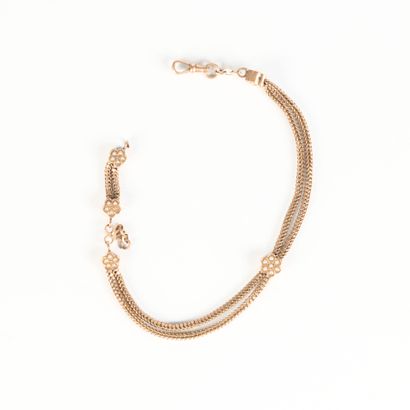 Two-row gold watch chain, motifs set with...