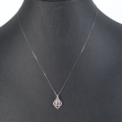 Platinum pendant set with an oval pink sapphire...