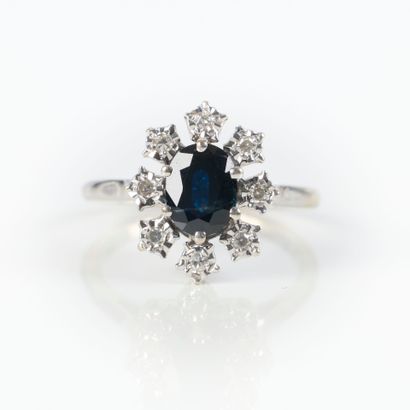 White gold ring set with an oval sapphire...