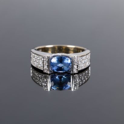 Gold ring set with an oval sapphire weighing...