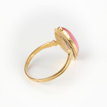 Gold ring set with a pink navette stone....