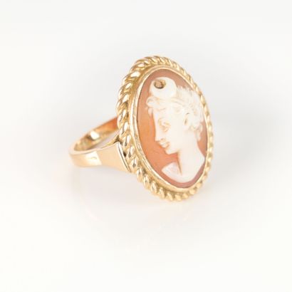 Gold ring set with a shell cameo engraved...