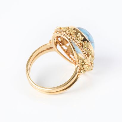 Two-tone gold ring set with a turquoise cabochon...