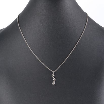 White gold pendant set with three small pierced...