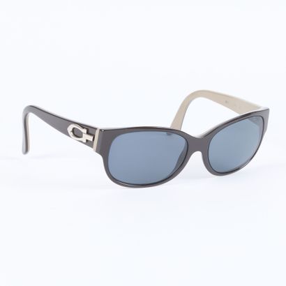 CARTIER. Pair of black and grey plastic sunglasses...