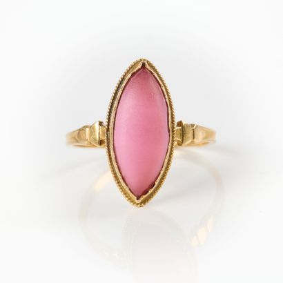 Gold ring set with a pink navette stone....